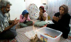 poverty in Iran family sit on floor while eating